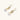 Gold sunburst charm earrings with baroque pearl drops on French hooks against cream background