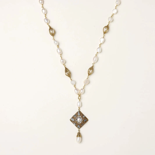 Y-shaped necklace with freshwater pearls, gold filigree stations, and ornate diamond-shaped centerpiece with pearl drop
