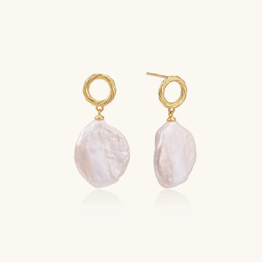 18K gold vermeil twisted circle studs with organic white baroque pearl drops on cream background
