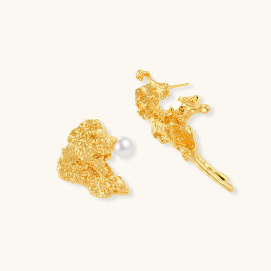 Textured gold stud earrings with coral-like organic surface, one featuring a freshwater pearl, displayed on white background.