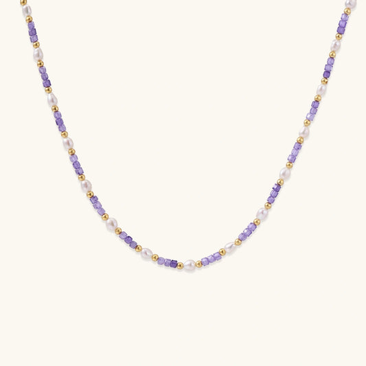 Delicate 18K gold vermeil necklace with alternating lavender zirconia beads and white freshwater pearls on cream background