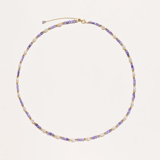 Delicate 18K gold vermeil necklace with alternating lavender zirconia beads and white freshwater pearls on cream background
