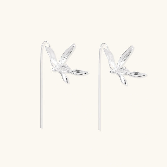 Delicate sterling silver dragonfly earrings with textured wings and curved threader hooks on white background