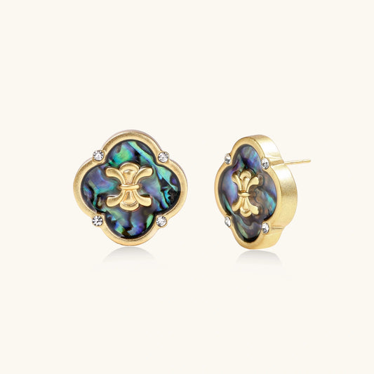 Gold quatrefoil stud earrings with iridescent abalone shell inlay and fleur-de-lis center, accented by four crystals