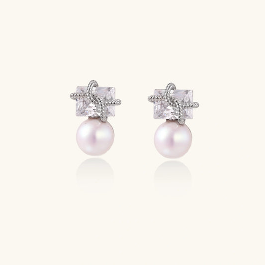 White gold stud earrings with square crystal stones in twisted frames and pink freshwater pearl drops below