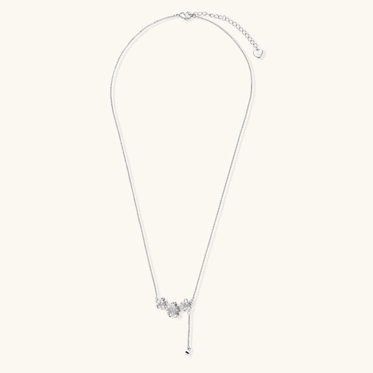 White gold plated Y-shaped necklace with three dimensional flower charms and adjustable drop pendant