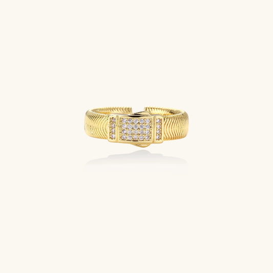 Gold-plated adjustable ring with ribbed band and rectangular pavé cubic zirconia panel on white background.