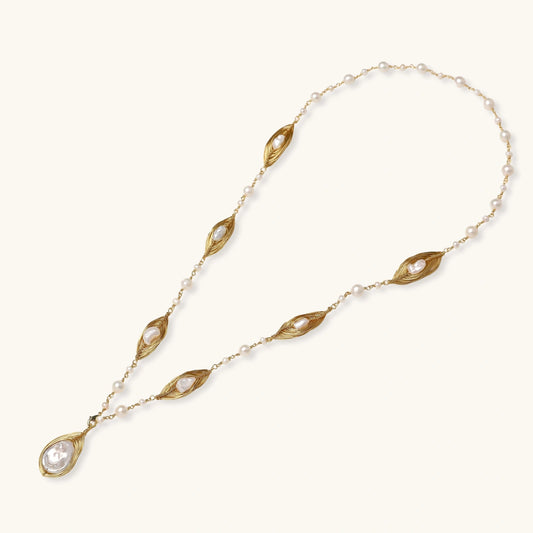14K gold plated necklace with organic leaf motifs and freshwater pearls arranged in an elegant chain design on neutral background.
