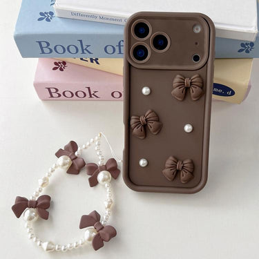 Soft Silicone 3D Bowknot Pearl Phone Case with Beaded Wrist Strap, For iPhone 17 Pro Max, For iPhone 17 Pro, For iPhone 17, For iPhone Air, For iPhone 16 Pro Max, For iPhone 16 Pro, For iPhone 16, For iPhone 15 Pro Max For iPhone 17 Pro Max / Coffee