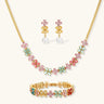 Gold-plated jewelry set with pink, turquoise and red flower-shaped cubic zirconia stones, featuring necklace, earrings and bracelet.