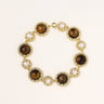 Gold-plated link bracelet with alternating brown tiger's eye stones and white freshwater pearls in ornate bezels.