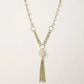 Long gold-plated necklace with freshwater pearls, chunky chain links, and flowing tassel pendant
