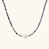 Dainty necklace with faceted purple iolite beads, gold vermeil accents, and central pink-white freshwater pearl.