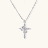 White gold-plated cross pendant adorned with sparkling zirconia stones and crescent moon accent on ball chain