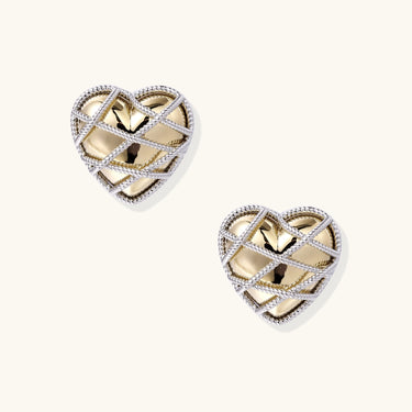 Heart-shaped stud earrings with intricate lattice design in 18K gold plated brass and silver-tone metal.