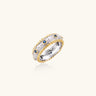 Two-tone ring with brushed silver center, gold beaded edges, and blue zirconia stones on white background.