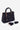 A black pebbled leather handbag with gold-tone hardware, featuring a top handle, a flower-shaped charm, and a detachable shoulder strap, displayed on a light gray background.